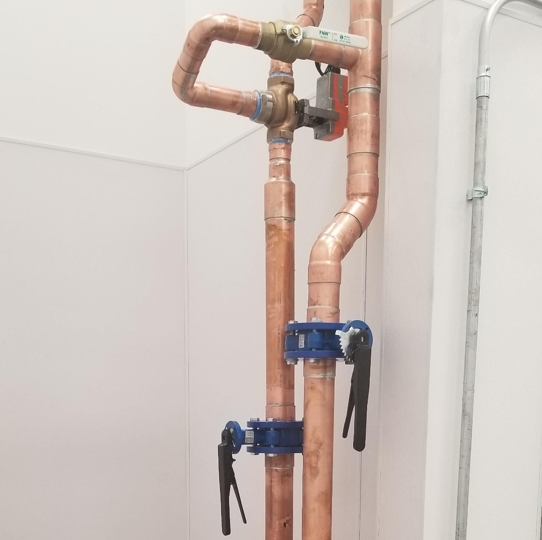 Neat copper pipe risers with blue butterfly valves